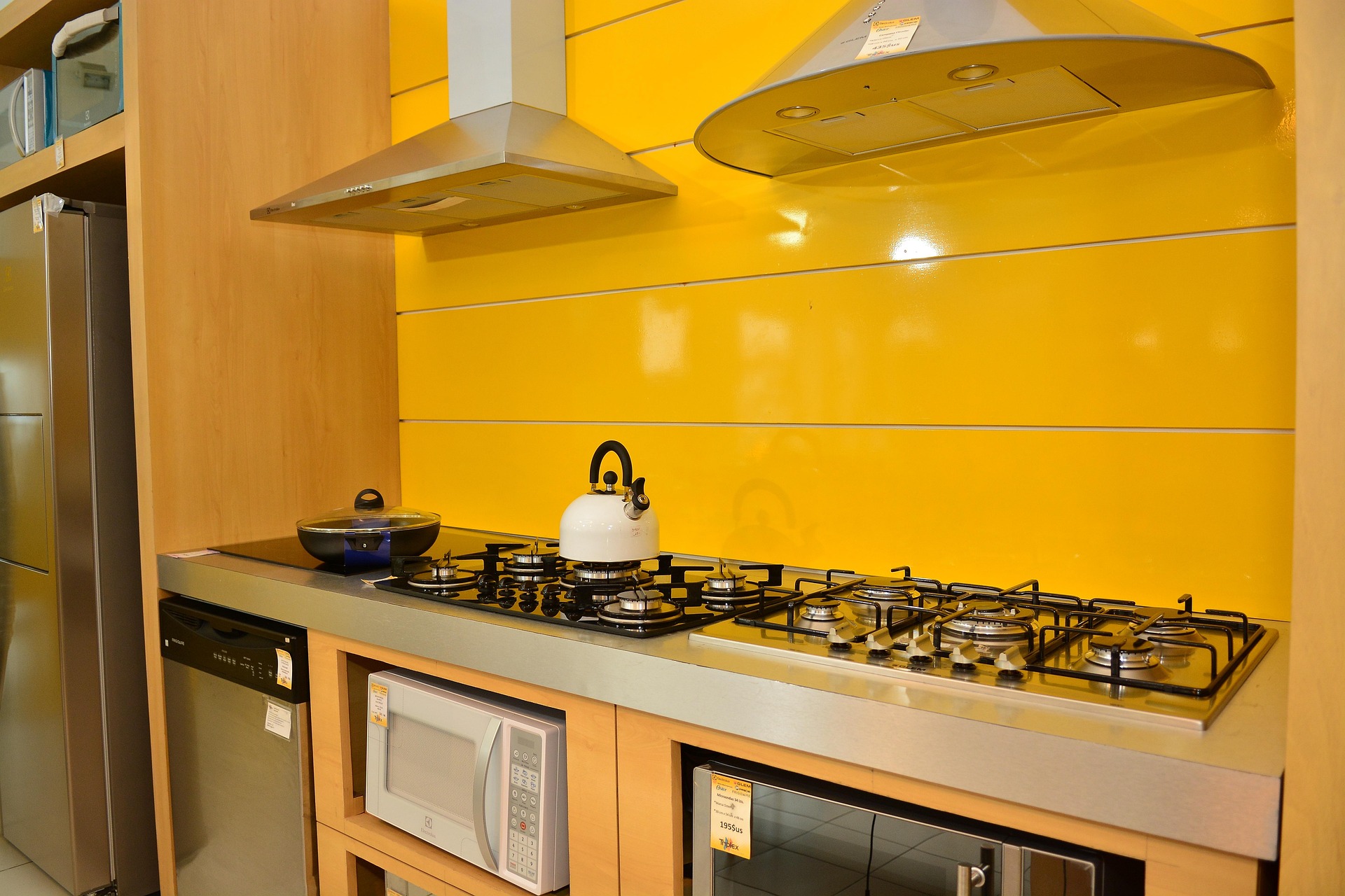 Wall-mounted kitchen range hood above a cooking surface